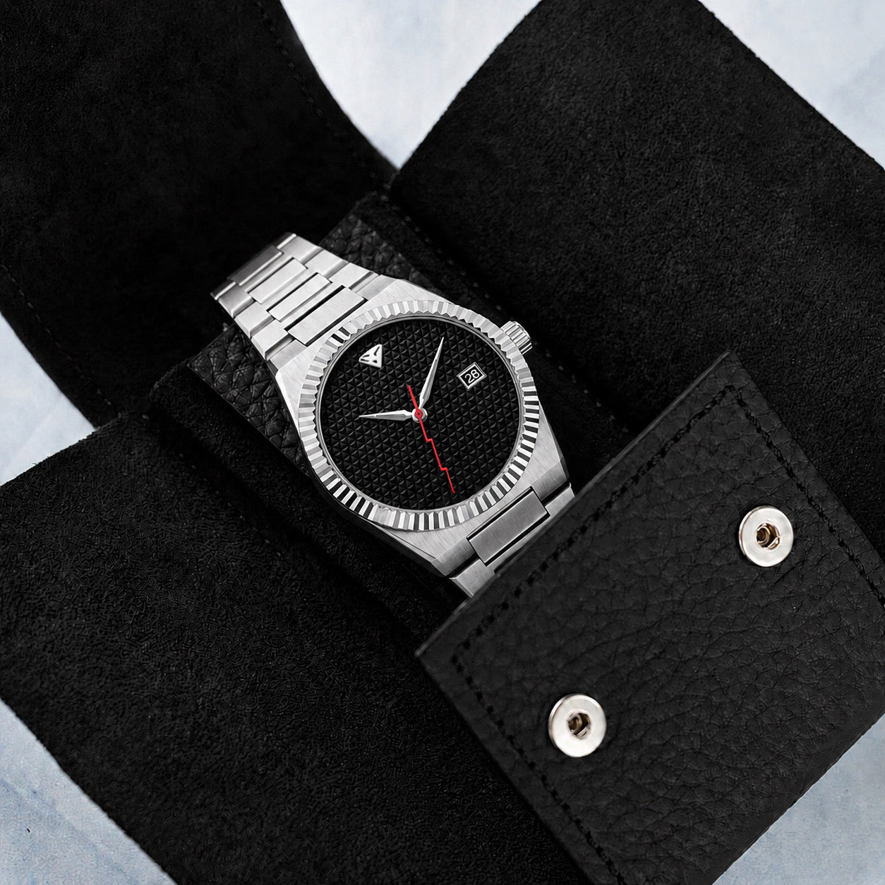 Open pouch with watch on soft suede interior