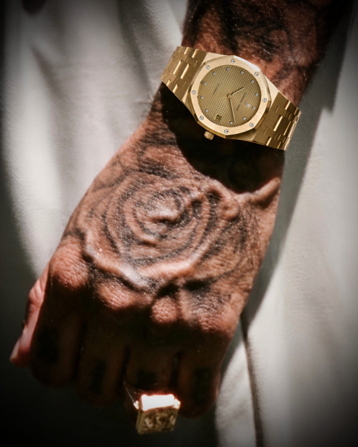Close-up of Tyga’s wrist showing the yellow-gold Royal Oak, champagne dial and diamond hour markers