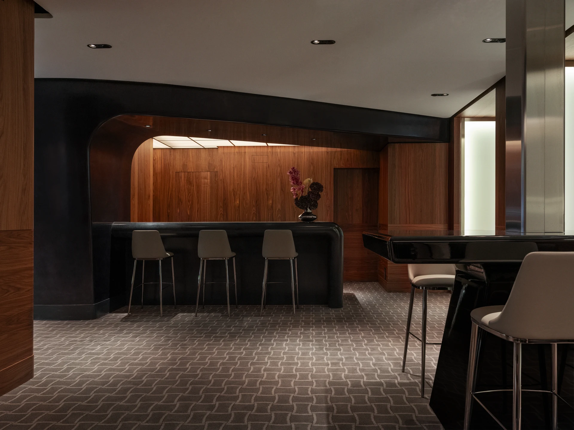 Walnut-panelled coffee bar with stools at the Nymans Ur Stockholm flagship