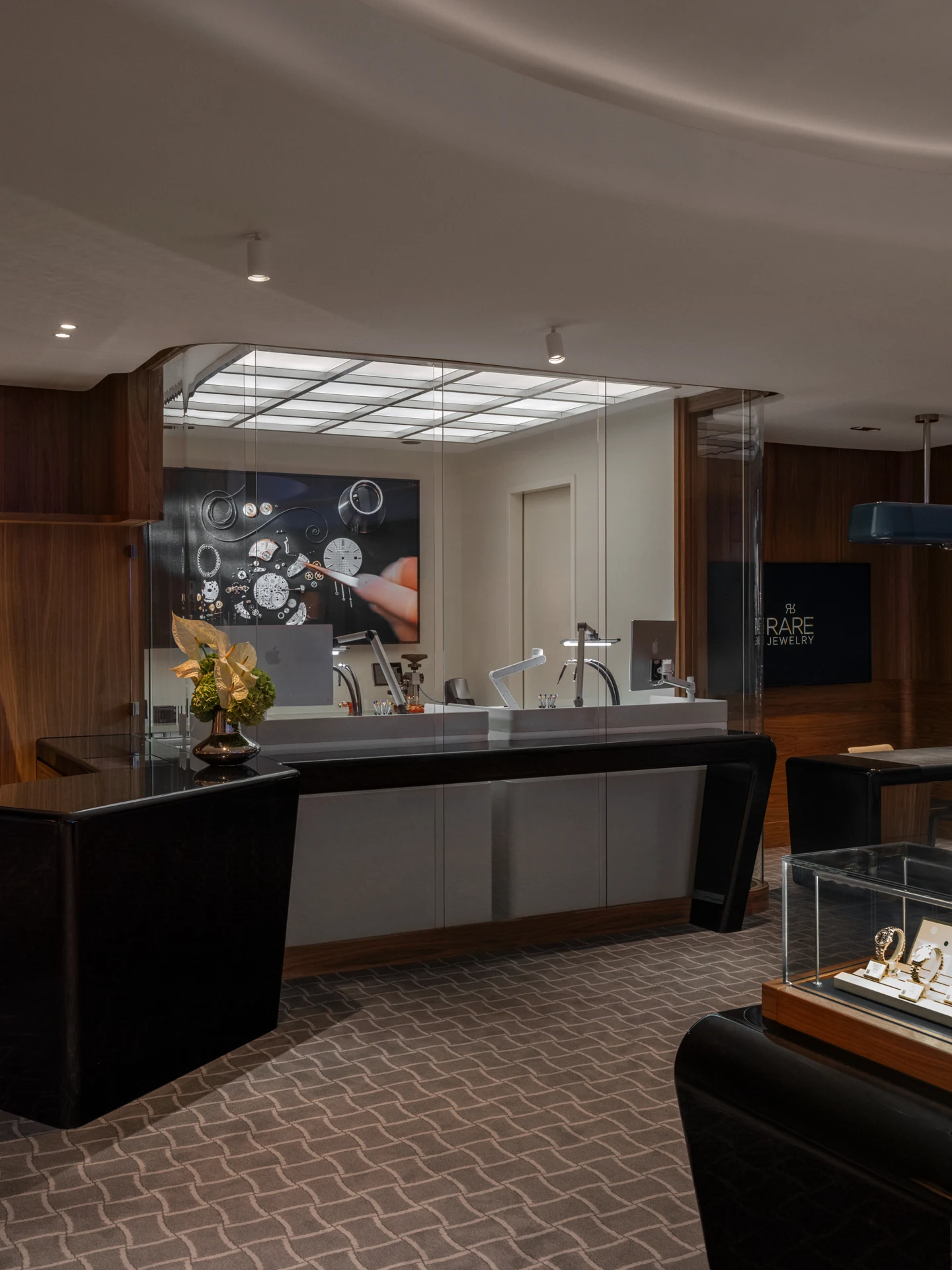 Glass-fronted watchmaking workspace beside the Nymans Ur shop floor